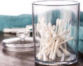 Cotton swabs in clear plastic jar in bathroom setting Royalty Free Stock Photo