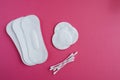 Cotton swabs and disks isolated on a pink background. Hygiene products