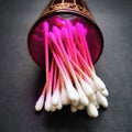 Cotton swabs in a pink cup on a black background. Royalty Free Stock Photo
