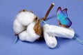 Cotton tampon, intimate hygiene, gynecological menstruation cycle. Blue butterfly on a cotton tampon.