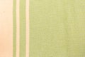 Cotton textile with green and beige stripes - close up of fabric texture. Cotton Fabric Texture. Top View of Cloth Textile Surface