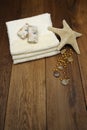 Cotton towel, sea star, spa products on the wood s