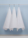 cotton waffle towels for the kitchen hang on hooks on a bracket against