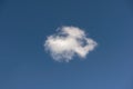 Cotton wool cloud floating in huge blue sky