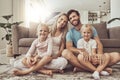 Couch, happy family and parents with children on living room floor and relax by sofa together in the morning. Love, care Royalty Free Stock Photo