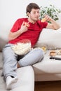 Couch potato eating junk food Royalty Free Stock Photo