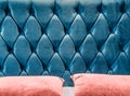 Couch-type velours screed on headboard tightened with buttons. Blue chesterfield style quilted upholstery backdrop close Royalty Free Stock Photo