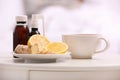 Cough syrups, lemon and cup of tea on table Royalty Free Stock Photo