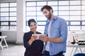 We could make this go global. two young designers working together on a digital tablet in an office. Royalty Free Stock Photo