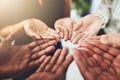 We could use some additional help on this one. Closeup shot of a group of businesspeople standing with their hands