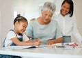 Could you draw grandma. a young girl getting help from her mother and grandma while doing her homework at home. Royalty Free Stock Photo