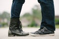 Coule facing each other in black leather shoes.