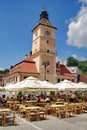 Landmark attraction in Brasov, Romania: Tourists in the Council Square and the Council House Royalty Free Stock Photo