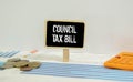 COUNCIL TAX BILL, the paper is clamped with a clerical clip. paper on wood background.