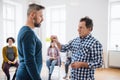 Counsellor putting an adhesive note with the word angry on client during group therapy.