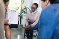 Counselor giving support to depressed crying man at group psychological treatment Royalty Free Stock Photo