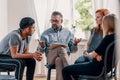 Counselor talking with rebellious teenagers with depression Royalty Free Stock Photo