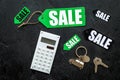 Count the benefits from the sale. Word sale on label near calculator on black background top view Royalty Free Stock Photo