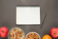 Count calories of healthy food snecks: oatmeal, almonds, apple, orange. Royalty Free Stock Photo