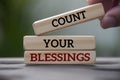 Count your blessings text on wooden blocks with blurred park background. Blessing concept Royalty Free Stock Photo