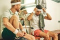 The countdown to squash madness. two young men getting dressed in the locker room after a game of squash. Royalty Free Stock Photo