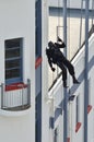 Counter-terrorism police officer abseiling a building