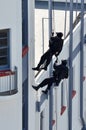 Counter-terrorism police officers abseiling a building