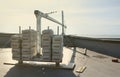 Counter weight or weight balance concrete blocks or bricks as part of suspended wire rope platform for facade works on Royalty Free Stock Photo