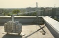 Counter weight or weight balance concrete blocks or bricks as part of suspended wire rope platform for facade works on Royalty Free Stock Photo