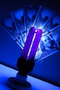 Counterfeit money checking with ultraviolet lamp. Fraud crime Royalty Free Stock Photo