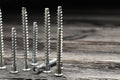 Countersunk screws on wooden table, closeup. Space for text Royalty Free Stock Photo