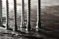 Countersunk screws on wooden table, closeup. Space for text Royalty Free Stock Photo