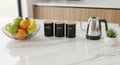 Countertop featuring a white marble surface. Items include a fruit Royalty Free Stock Photo