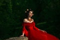 Countess in long red dress sitting with his eyes closed. Royalty Free Stock Photo