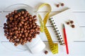 Counting and recording the amount of calories, proteins, carbohydrates and fats in food. Hazelnut on kitchen scales Royalty Free Stock Photo