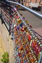 Countless, colorful love padlocks hanging on a railing at the river Ilmenau in Lueneburg