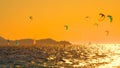 Countless kitesurfers and windsurfers are riding waves near Peljesac at sunset. Royalty Free Stock Photo