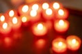 countless red lit church candles in blurred image Royalty Free Stock Photo