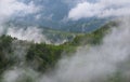 Countrified Summer Foggy Landscape Of Apuseni National Park In Romania. Rural House On A Green Forest Slope Among The Romanian Mo