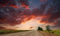 Country asphalt road leaving into the dramatic sunset sky Royalty Free Stock Photo