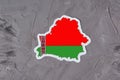 Country border outline map of Belarus. Shape and national flag of the Republic of Belarus on grey concrete background. Election