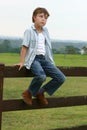 Country boy sitting on a fence Royalty Free Stock Photo