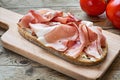 Country bread with smoked ham bacon on a wooden board Royalty Free Stock Photo