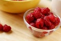 A country breakfast with pile of ripe raspberries, and porridge