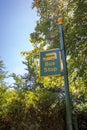 Country bus stop. Rural sign post painted yellow and green.