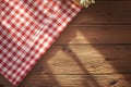 Country charm Red checkered tablecloth gracing a rustic wooden table Royalty Free Stock Photo