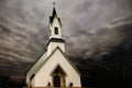 White Country Church with a stormy sky in the background Royalty Free Stock Photo