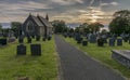 Country church and graveyard at sunset