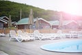 Country club recreation recreation relax pool wooden house forest trees sun lounger umbrella. Royalty Free Stock Photo