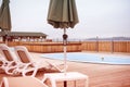 Country club recreation recreation relax pool wooden house forest trees sun lounger umbrella. Royalty Free Stock Photo